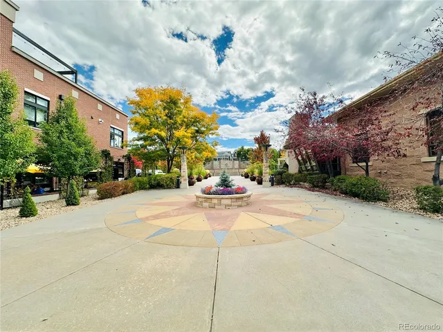 a view of a street with potted plants