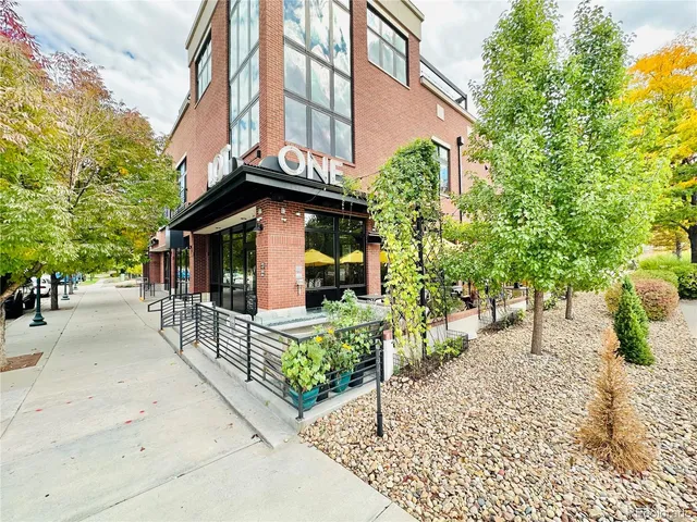 an outdoor view of a building with sitting area