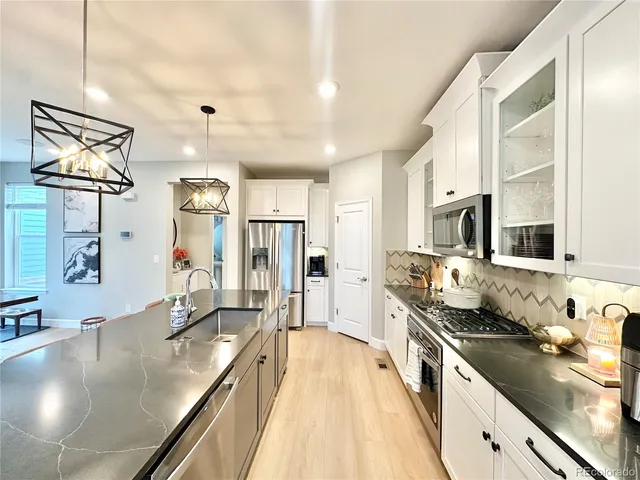 a large kitchen with stainless steel appliances a lot of counter space and a sink