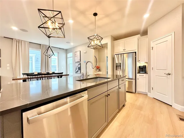 a view of a kitchen with a sink and refrigerator