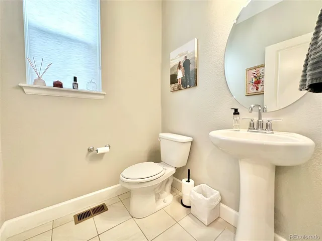 a bathroom with a sink toilet and mirror