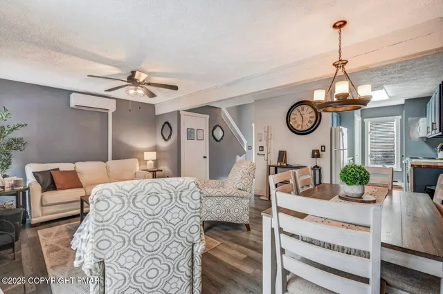 a living room with furniture a clock and a window