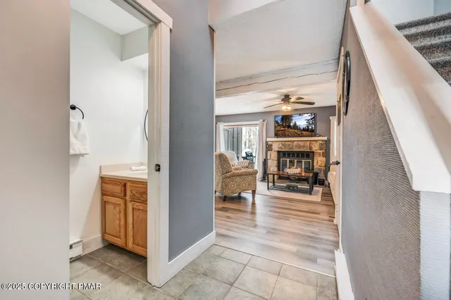 a view of living room with furniture and workspace