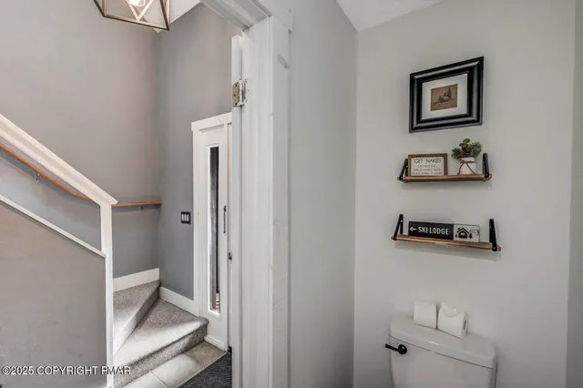a view of staircase with white walls and a window