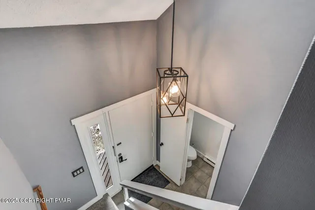 a view of a hallway with wooden floor and closet