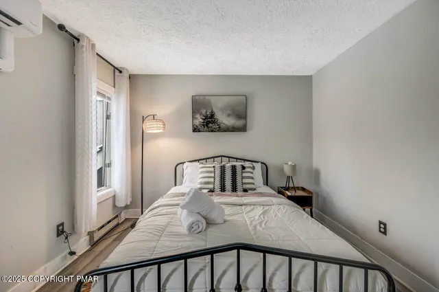 a bedroom with a bed and flat screen tv