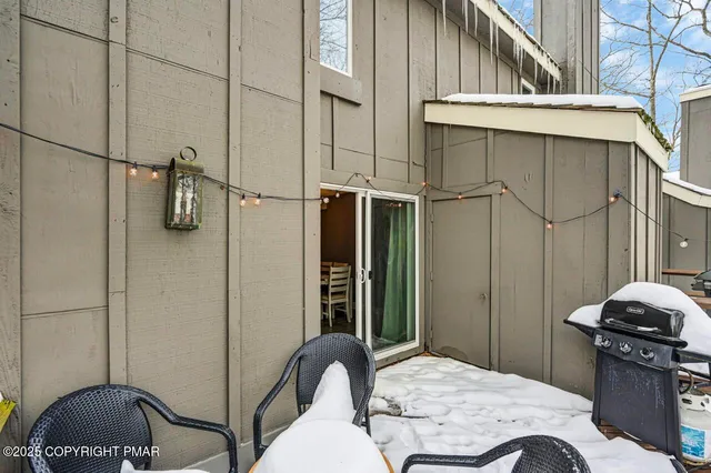 a view of a chairs and table in the balcony