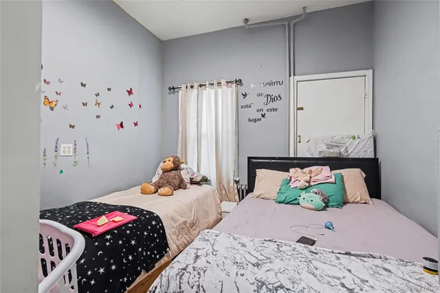 a bedroom with bed and wooden floor