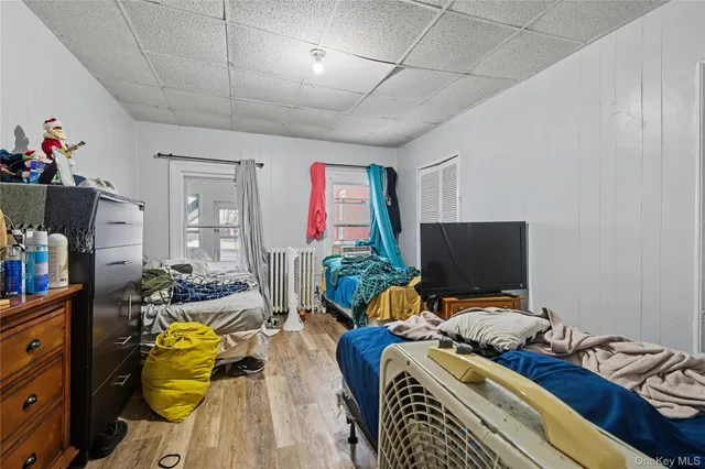 a bedroom with furniture and a flat screen tv