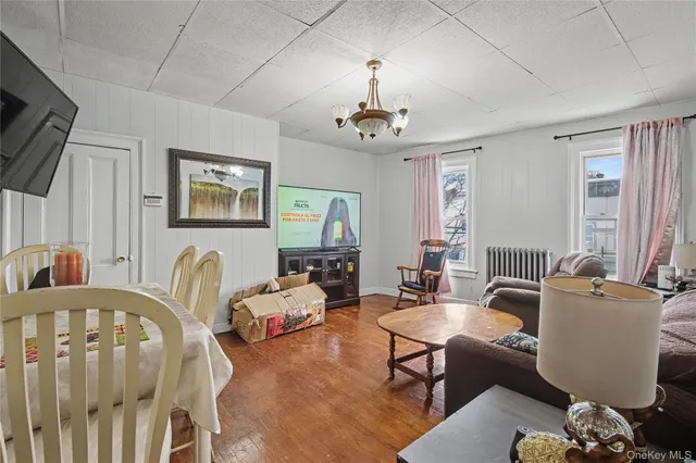 a living room with furniture a chandelier and a window