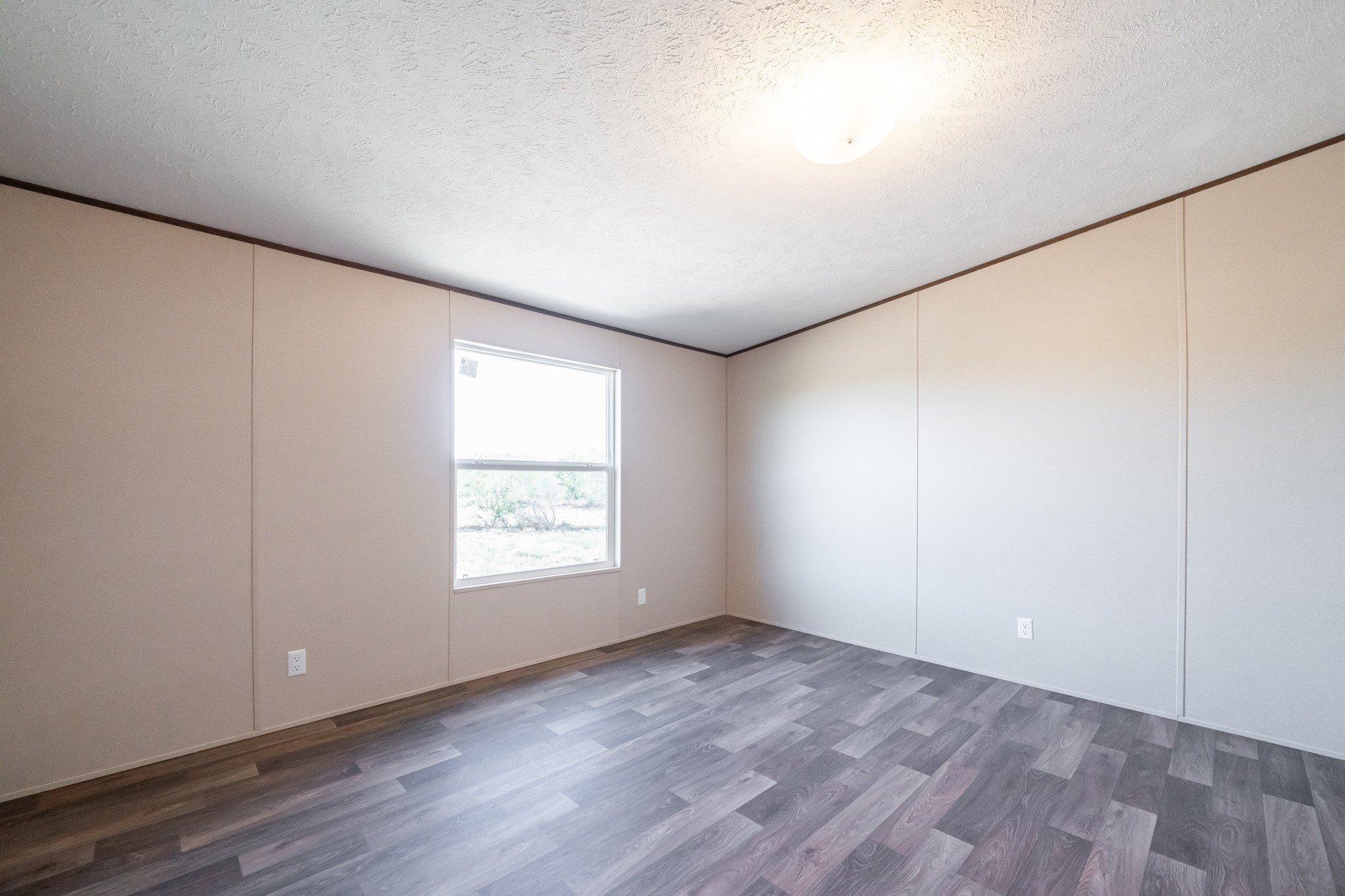 260 Pr Frio Estates Moore, TX 78057 - Photo 21 of 33 an empty room with wooden floor and window