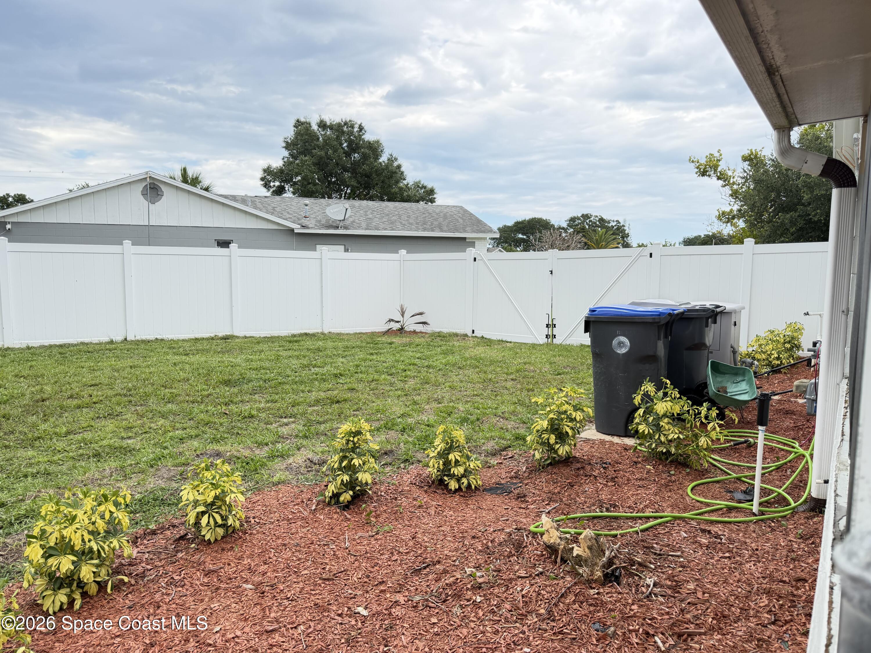 1578 West Powder Horn Road Titusville, FL 32796 - Photo 21 of 22 a view of a garden with lawn chairs