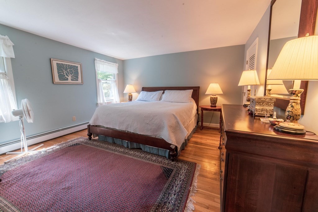 16 Main Street Boxford, MA 01921 - Photo 25 of 34 a bedroom with a bed table and window