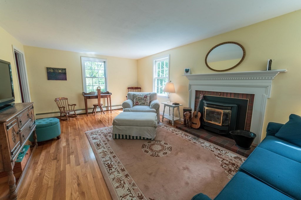 16 Main Street Boxford, MA 01921 - Photo 8 of 34 a living room with furniture and a fireplace