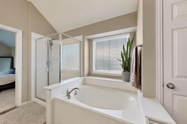 a bathroom with bathtub and shower