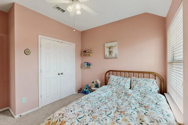 a bedroom with a bed and a dresser