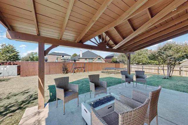 a view of a patio with a table and chairs