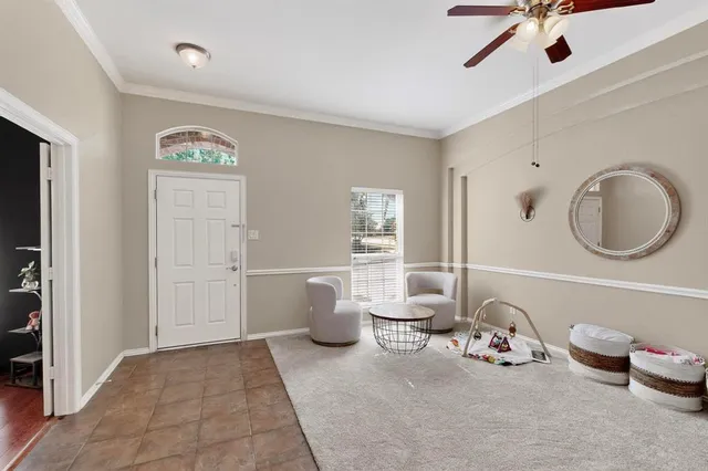 a spacious bedroom with a bed and a chandelier