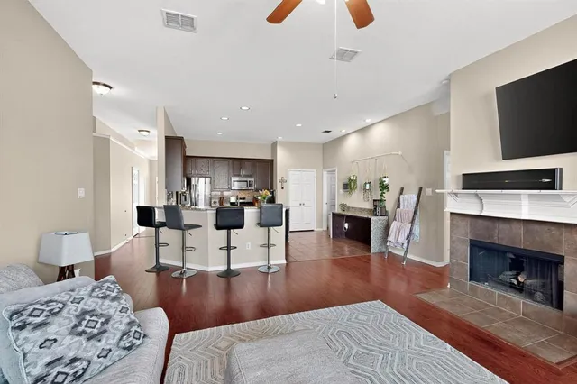 a living room with furniture a fireplace and a flat screen tv