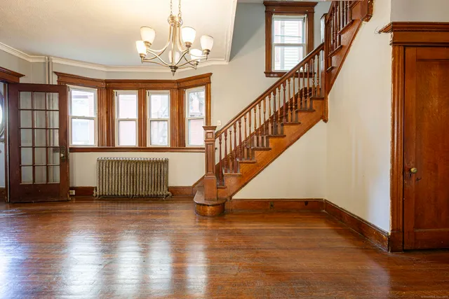 a view of entryway and hall with wooden floor
