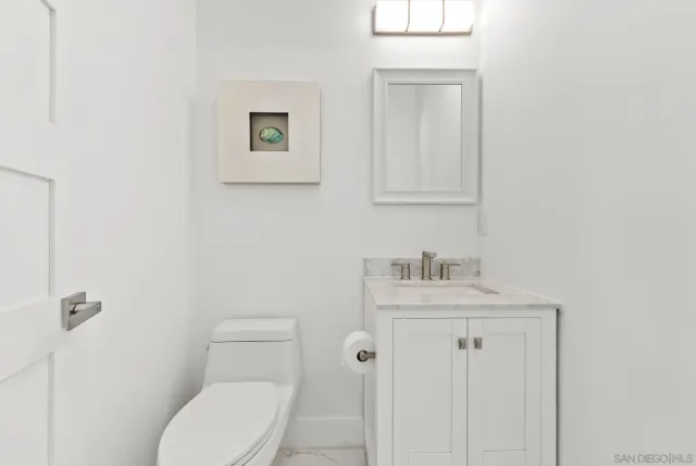 a view of a hallway with wooden floor and entryway