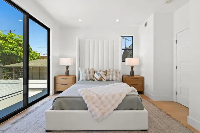 a bedroom with a bed and a chandelier