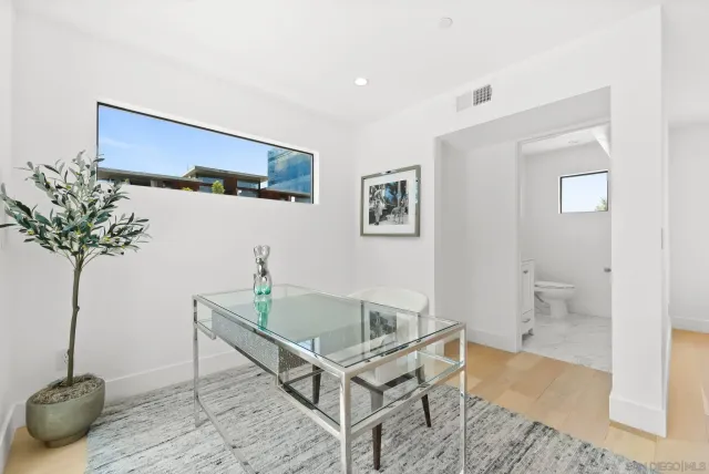 a bathroom with a granite countertop toilet and sink