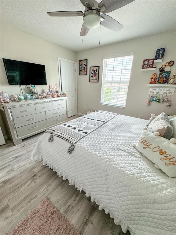 4499 Magnolia Ridge Court Kissimmee, FL 34746 - Photo 22 of 43 a bedroom with a bed and a flat screen tv
