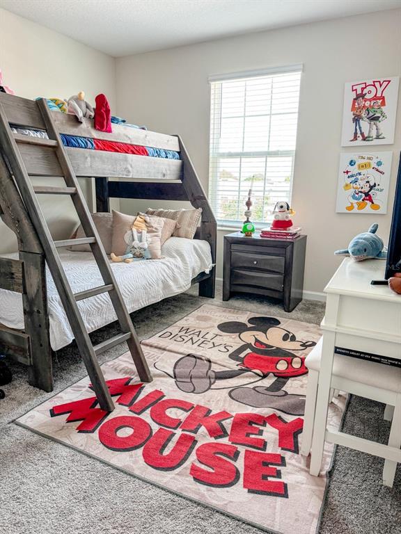 4499 Magnolia Ridge Court Kissimmee, FL 34746 - Photo 29 of 43 a bedroom with a bed and a dresser