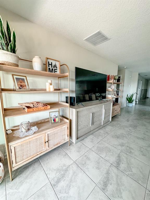 4499 Magnolia Ridge Court Kissimmee, FL 34746 - Photo 31 of 43 a kitchen with stainless steel appliances a stove and a microwave