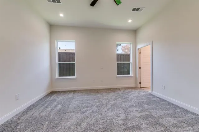 an empty room with windows and entrance