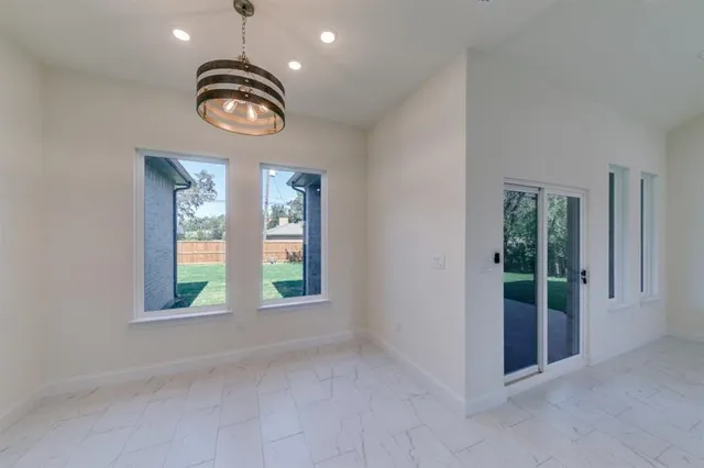 an empty room with windows and entrance