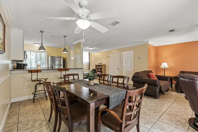 a view of a dining room and livingroom view with furniture wooden floor and a chandelier