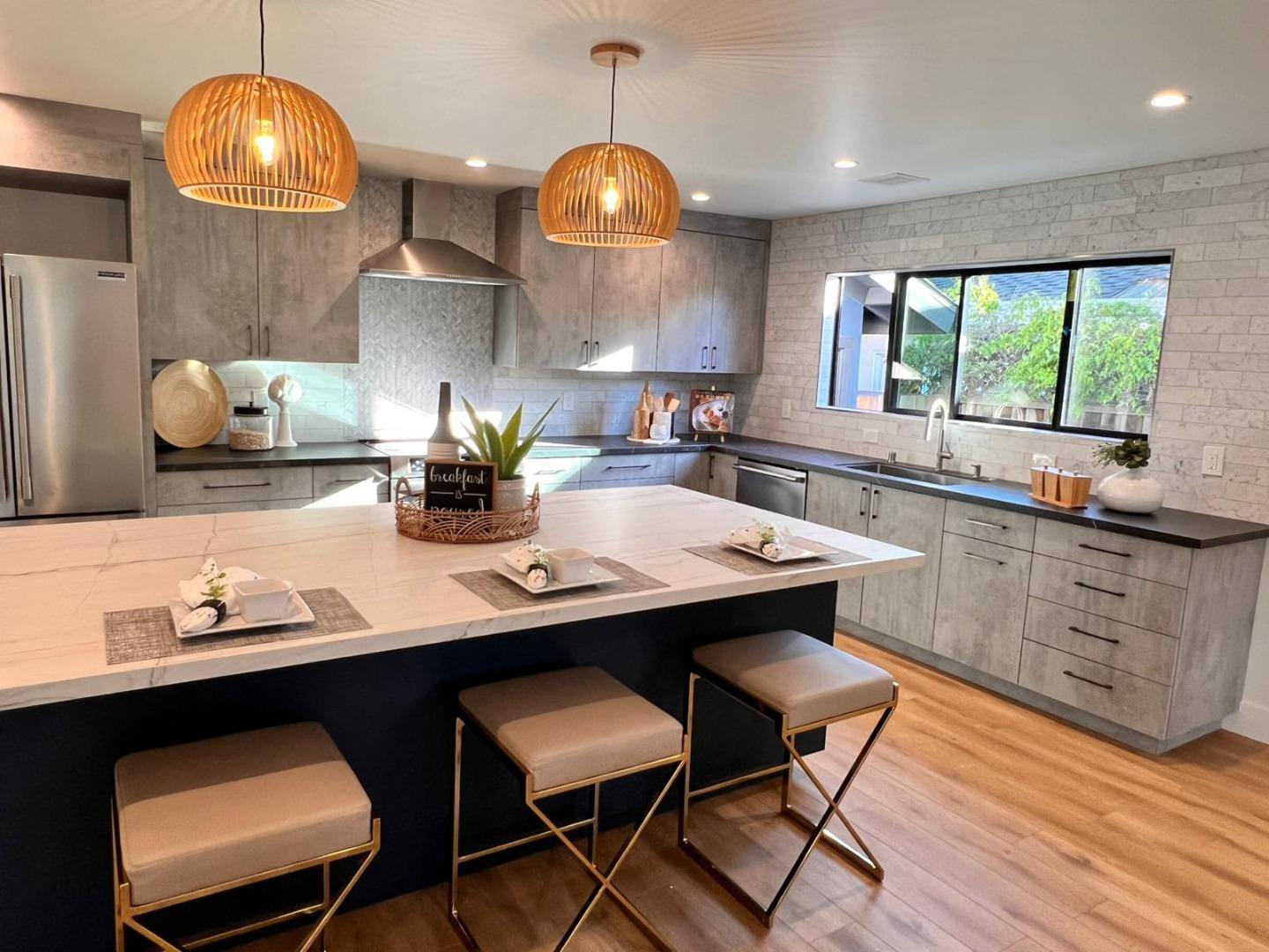 2038 Hoover Drive Santa Clara, CA 95051 - Photo 3 of 17 a kitchen with stainless steel appliances a dining table chairs and wooden floor