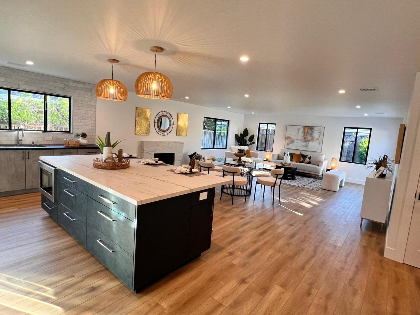 2038 Hoover Drive Santa Clara, CA 95051 - Photo 4 of 17 a kitchen with stainless steel appliances granite countertop wooden floors and view living room