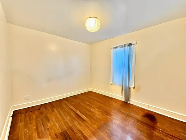 a view of a room with wooden floor and white walls