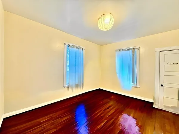 a view of room with wooden floor and window