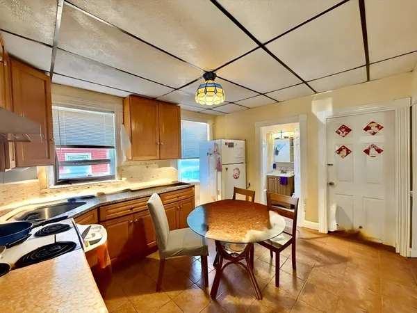 a view of a hallway with wooden floor and a bathroom