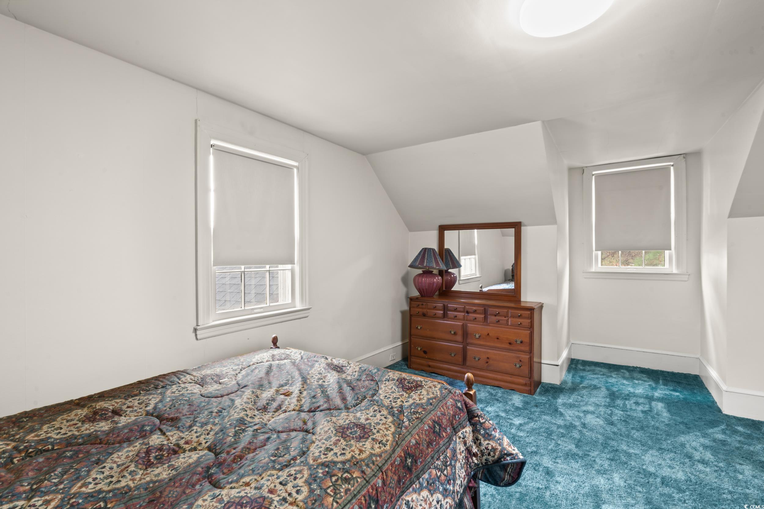 310 North Main Street Mullins, SC 29574 - Photo 18 of 35 Bedroom with dark carpet and lofted ceiling