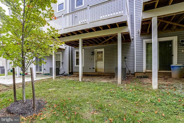 a view of a house with backyard porch and furniture