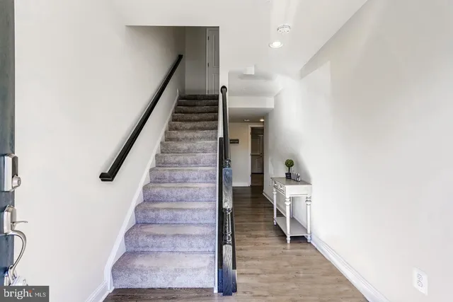 a view of entryway and hall with wooden floor
