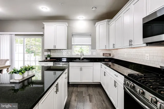 a kitchen with stainless steel appliances sink microwave and stove