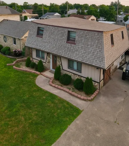 a front view of a house with a yard and green space