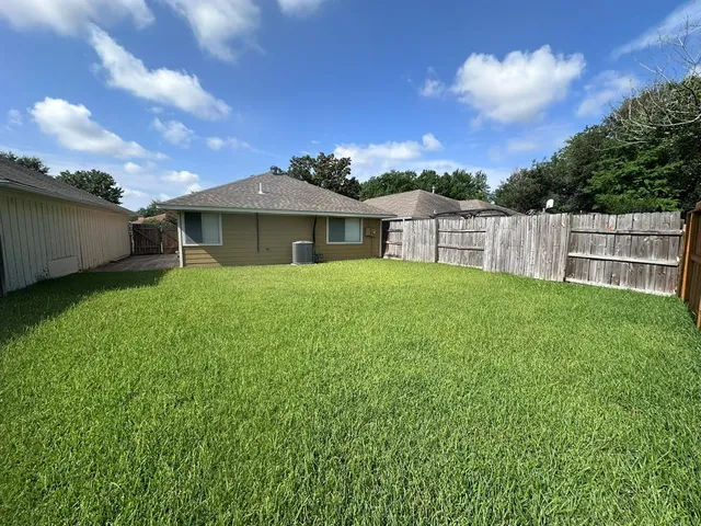 a view of a house with a yard and sitting area