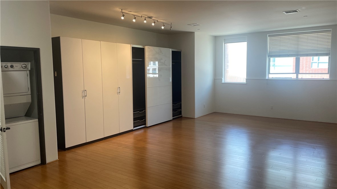 255 West 7th Street, Unit 13 San Pedro, CA 90731 - Photo 11 of 22 an empty room with wooden floor and windows