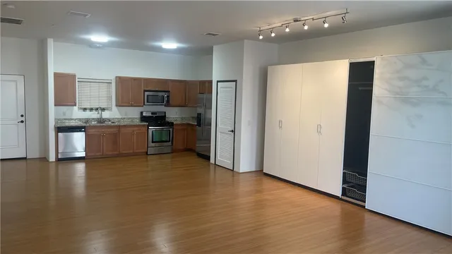 a view of a kitchen with a sink and a refrigerator