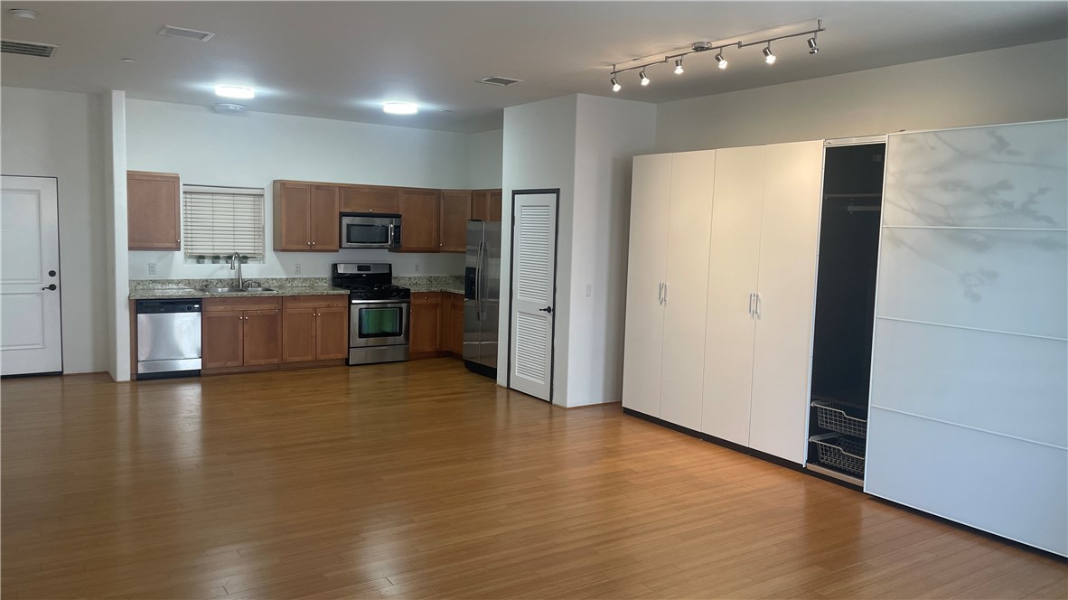 255 West 7th Street, Unit 13 San Pedro, CA 90731 - Photo 12 of 22 a view of a kitchen with a sink and a refrigerator