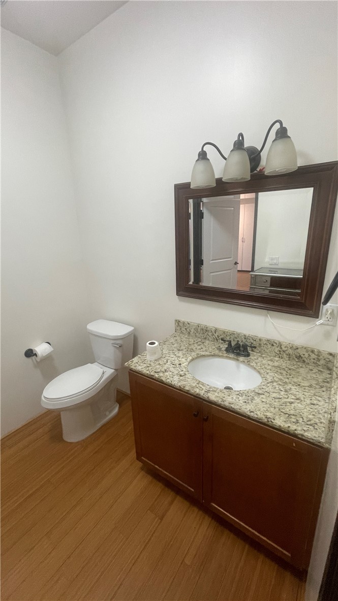 255 West 7th Street, Unit 13 San Pedro, CA 90731 - Photo 14 of 22 a bathroom with a toilet sink and mirror