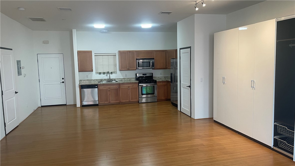 255 West 7th Street, Unit 13 San Pedro, CA 90731 - Photo 2 of 22 a view of a kitchen with a sink and a refrigerator