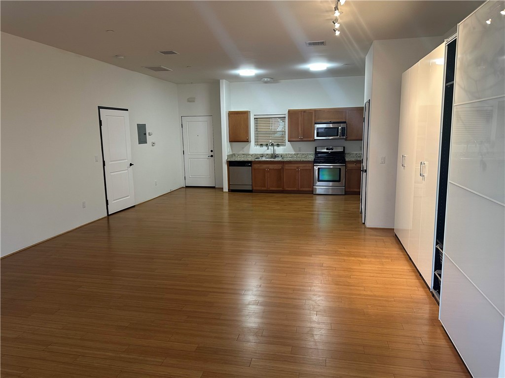 255 West 7th Street, Unit 13 San Pedro, CA 90731 - Photo 5 of 22 a view of a kitchen with kitchen island a counter top space stainless steel appliances and cabinets